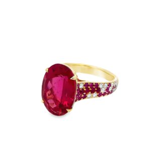 Oval cut rubellite tourmaline ring with rubies and diamonds set in 18 karat yellow gold